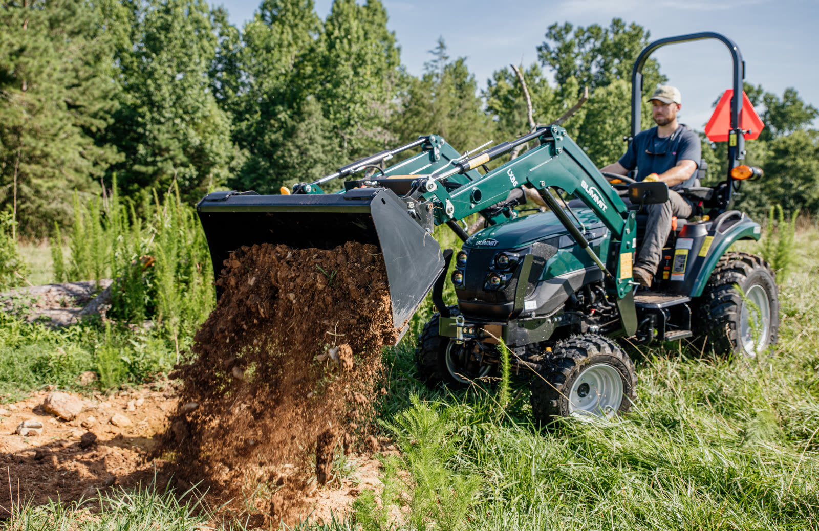 TX25H SSQA loader dumping soil in field